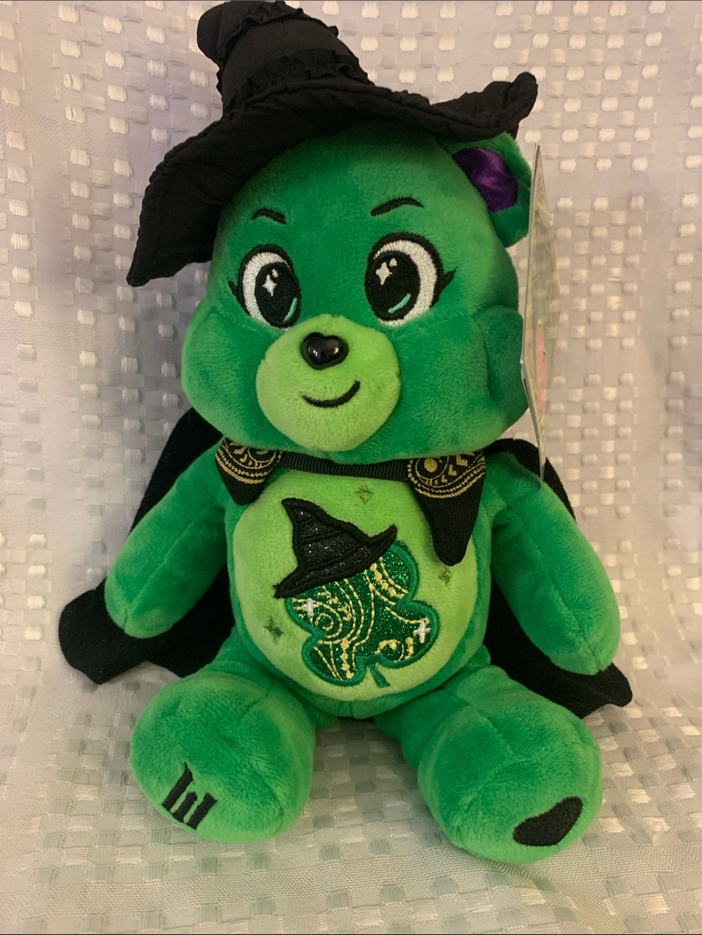 Green” Wicked “ Care Bear Plush with black witch’s hat and cape. 11 inches tall
